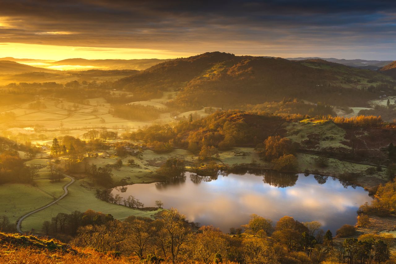 A stunning sunrise over the old Loughrigg Tarn at the heart of the English Lake District National Park, Cumbria, UK