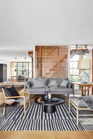 Living room with a black and white striped rug and a grey sofa