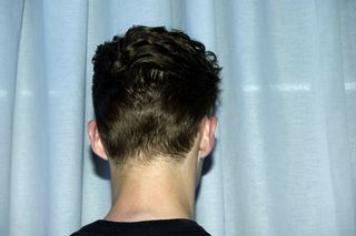 back of male model head with short and styled hair