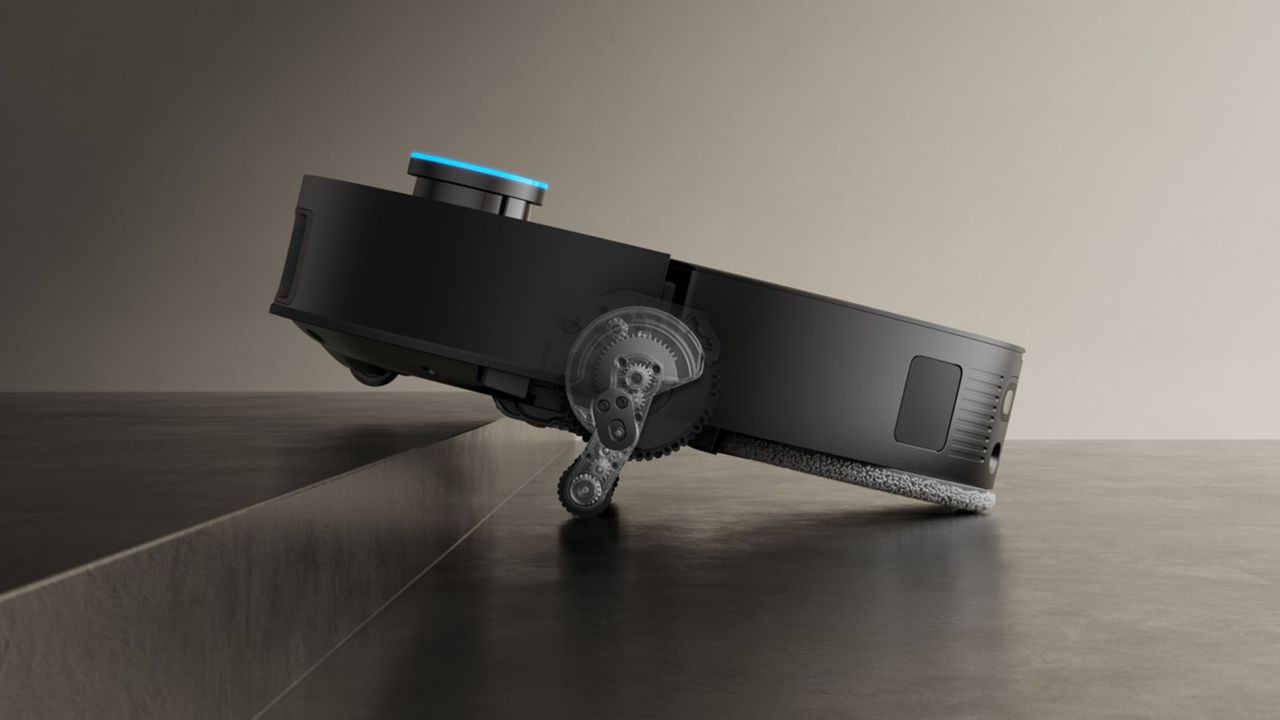 Black Dreame X50 Ultra Complete robot vacuum using its retractable legs to climb up a step