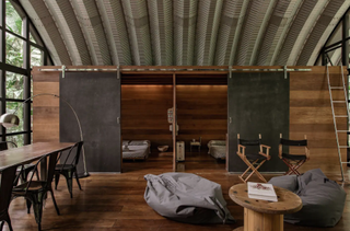 airbnb with curved corrugated roof and industrial table