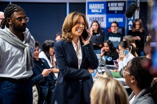 Kamala Harris wears a blue suit blazer with a white button down shirt and jeans while campaigning in Delaware