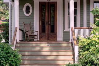 American covered front porch with a rocking chair outside the front door