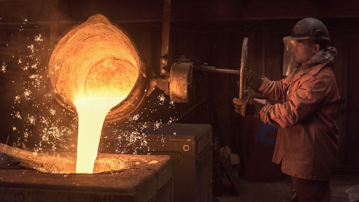 A man pours molten metal