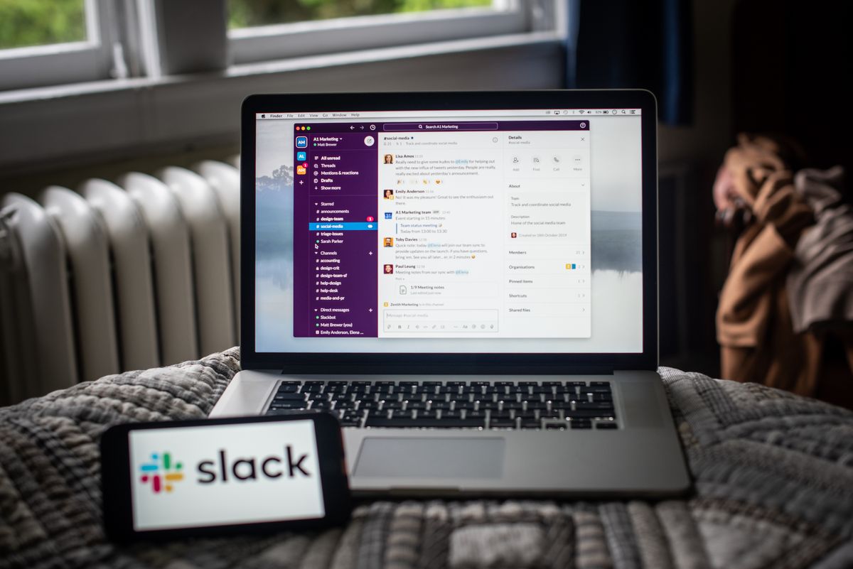 The Slack platform on a laptop computer and the company logo on a smartphone