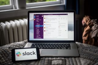 The Slack platform on a laptop computer and the company logo on a smartphone