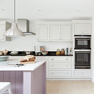 kitchen with white wall and drawer under oven