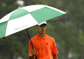 Guan Tianlang under a Masters umbrella