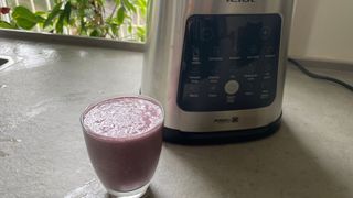 A glass of smoothie in front of the Tefal Perfectmix Blender