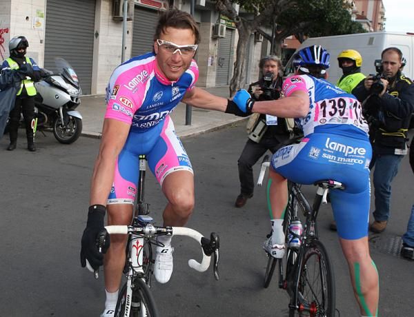 Alessandro Petacchi is congratulated by his teammate.
