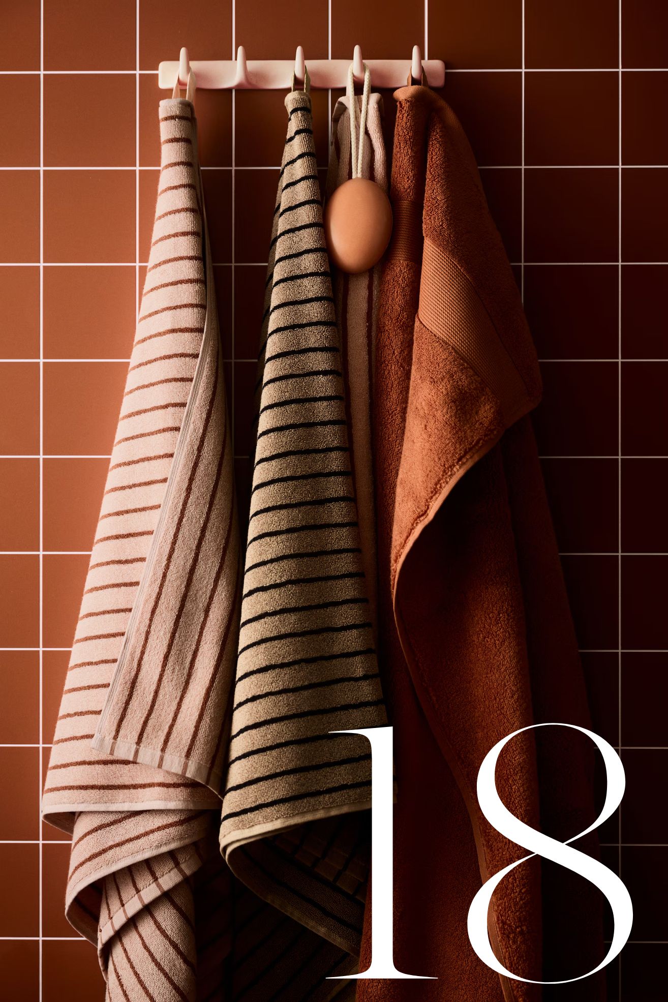 H&amp;amp;M striped towels hanging on wall