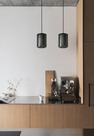 black smoked glass pendants in a scandi kitchen