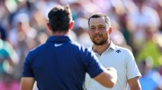 Xander Schauffele greets Rory McIlroy at the end of the 2024 Wells Fargo Championship third round