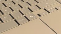Microsoft Copilot key highlighted on ASUS Zenbook A16 laptop in Zabriskie Beige