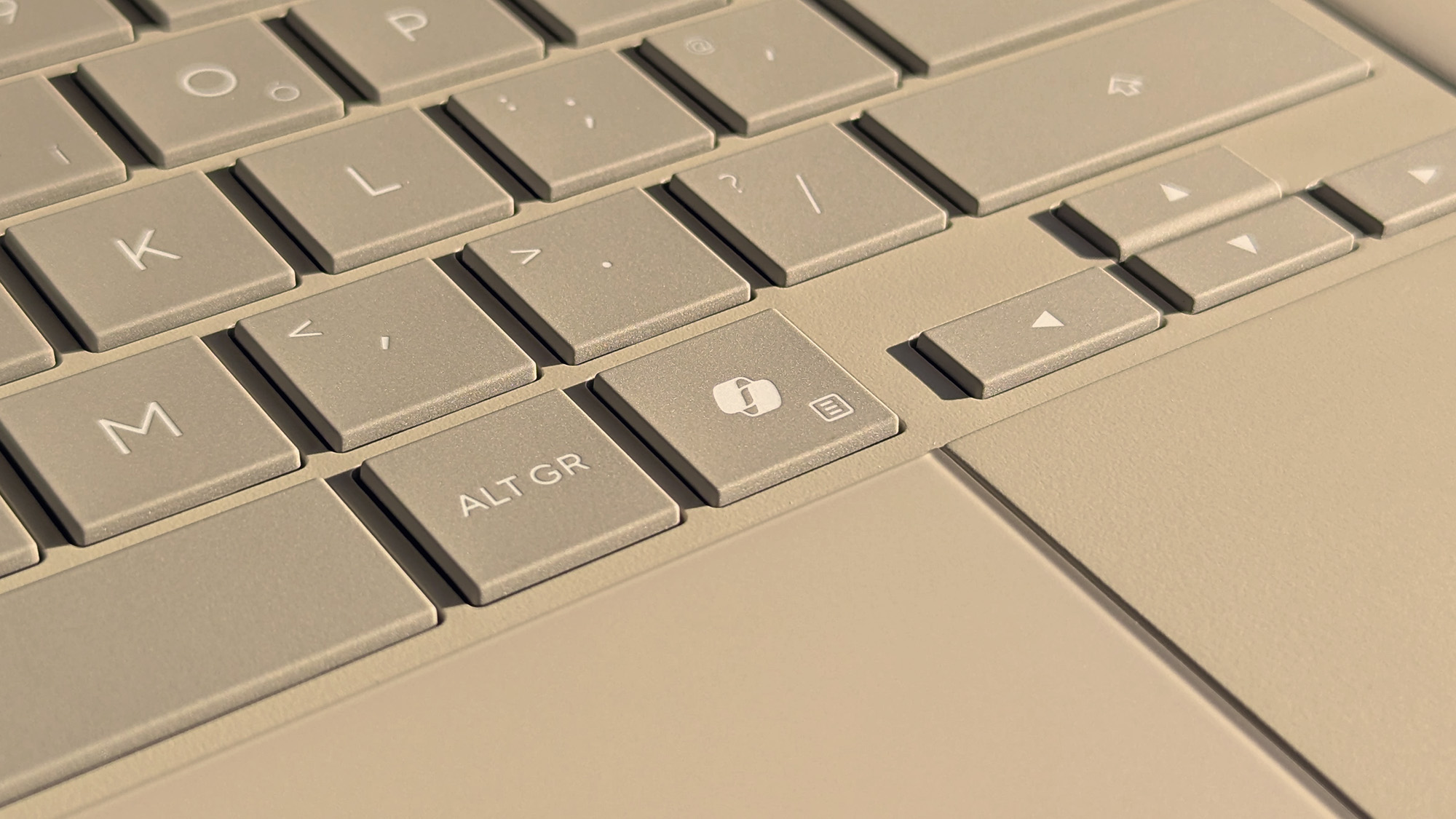 Microsoft Copilot key highlighted on ASUS Zenbook A16 laptop in Zabriskie Beige