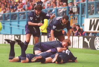 Jurgen Klinsmann and his Tottenham team-mates dive to the ground after the German's goal for Spurs against Sheffield Wednesday in 1994.
