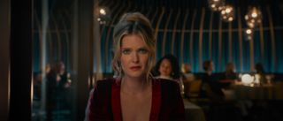 Meghann Fahy as Violet in a restaurant in Drop