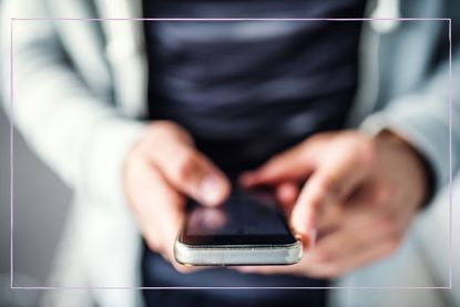 Anonymous boy looking at his phone