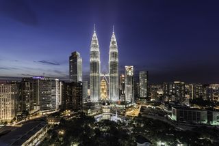 The Petronas Towers in Kuala Lumpur illuminated at night