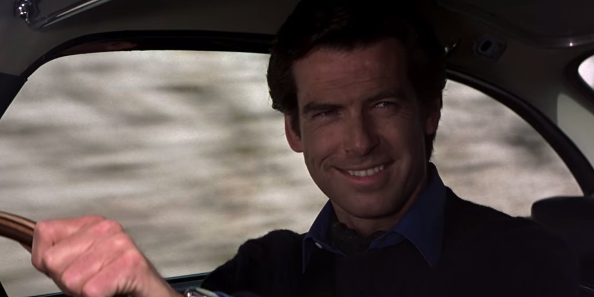 Goldeneye Pierce Brosnan smiling behind the wheel