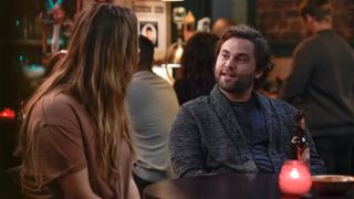 Jake Borelli as Schmitt at the bar in Grey's Anatomy season 21