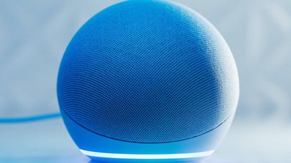 An Echo Dot lit up in blue
