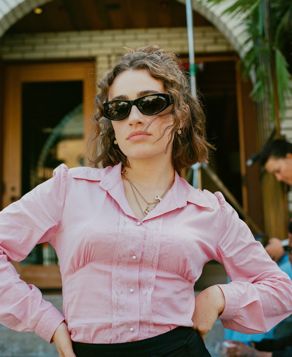 Rachel Sennot wearing a pink shirt and black skirt