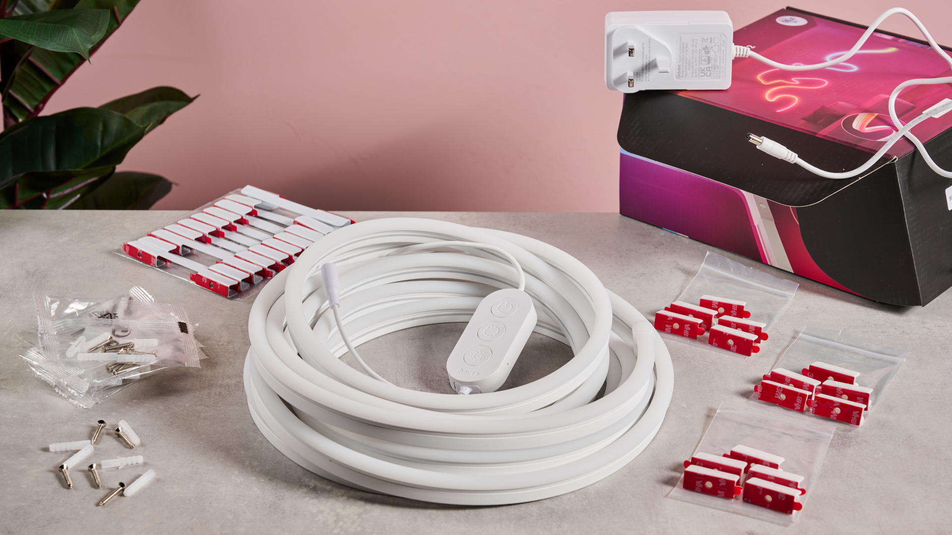 The rope light is coiled up and surrounded by the fixing accessories.