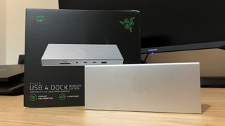 Razer USB 4 Dock with packaging on a wooden desk