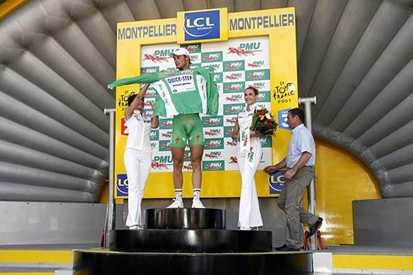 It takes three to put on a green jersey.