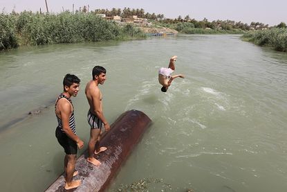 Iraqis try to cool off during the summer.