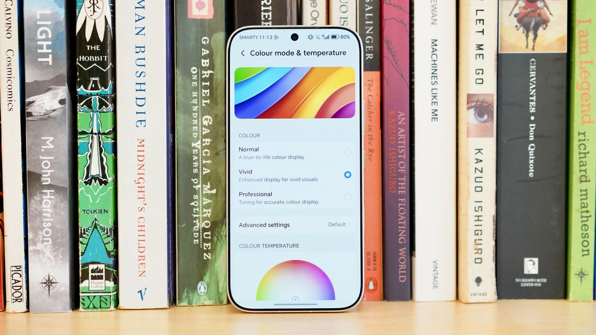 A white Honor 600 Pro resting on a wooden table