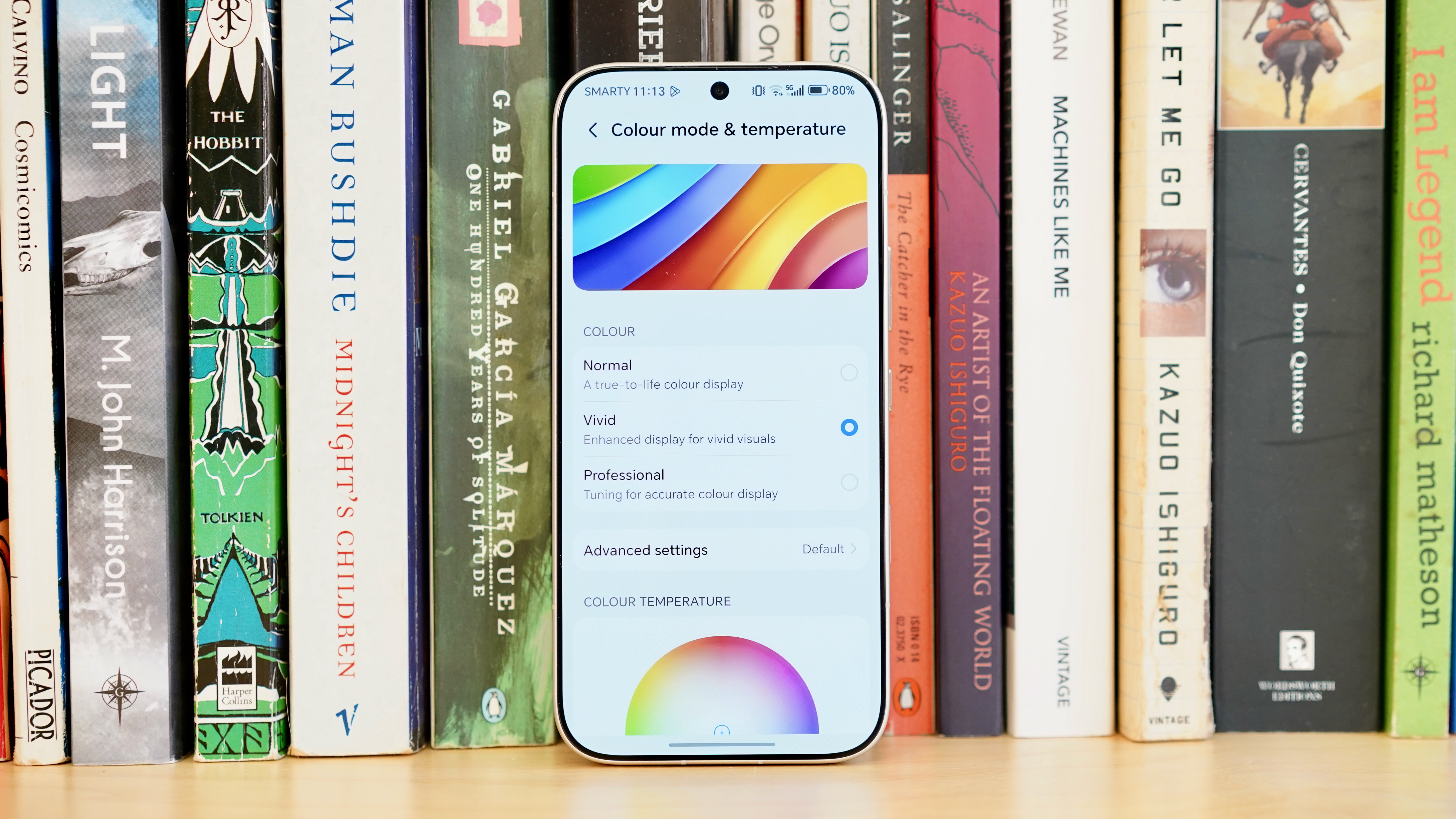 A white Honor 600 Pro resting on a wooden table