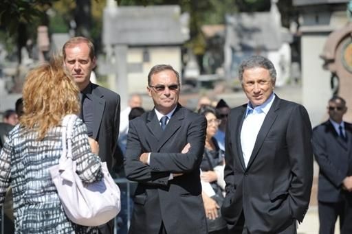 General director of the Tour de France Christian Prudhomme (L), five-times winner of the Tour de France Bernard Hinault (C) and TV host Michel Drucker (R) attend the funeral ceremony for French cycling champion Laurent Fignon