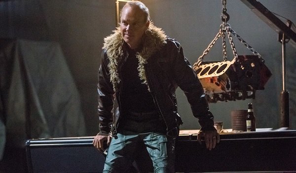 Spider-Man: Homecoming Michael Keaton sitting against his desk in the warehouse