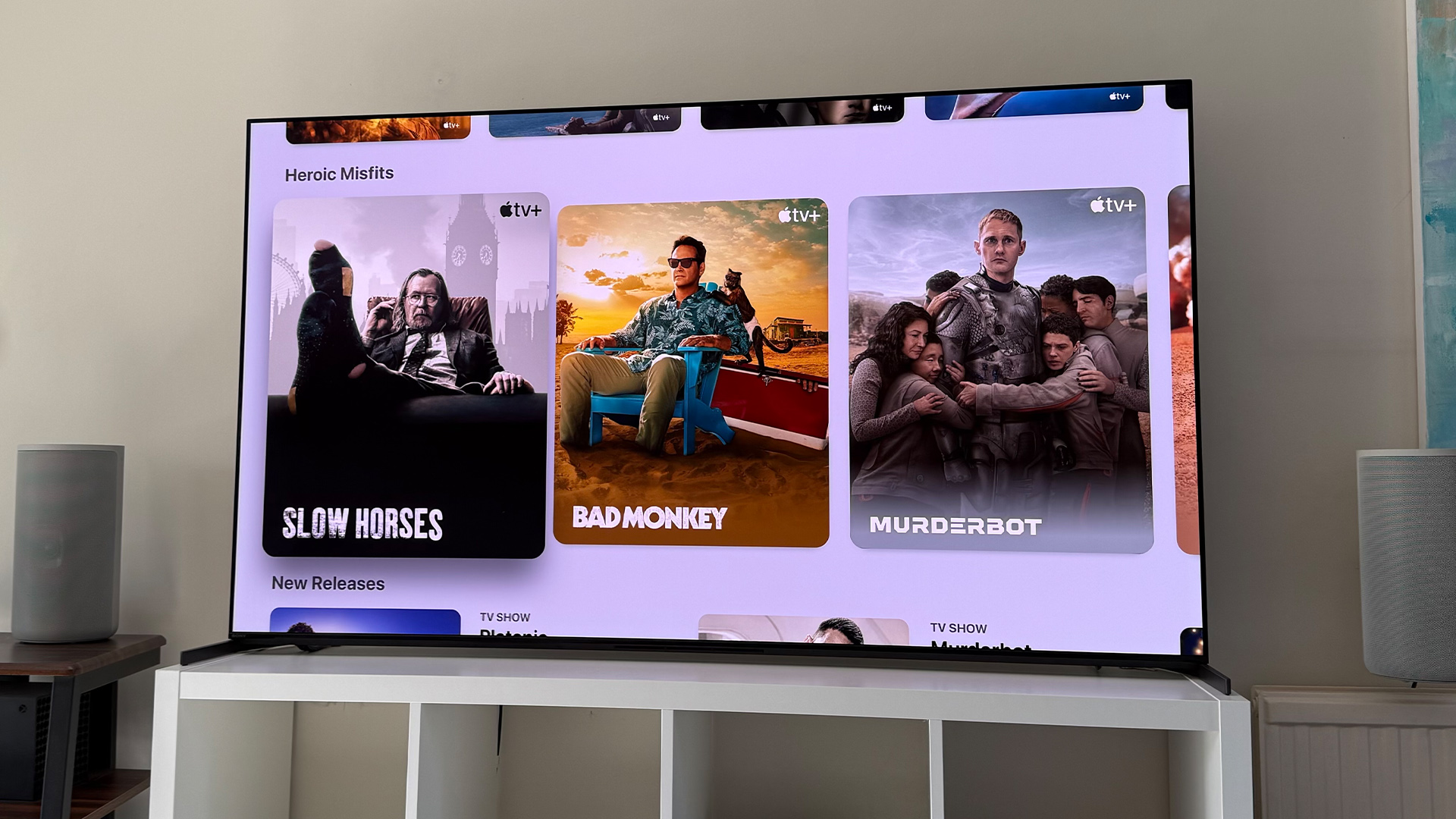 Apple TV+ TV streaming service on TV in living room, on screen is Apple TV+ home page