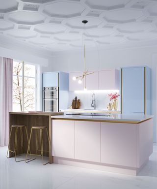 A kitchen with pastel pink island and pastel blue cabinetry with decorative coving on ceiling