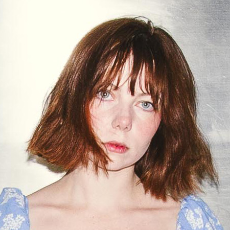 Portrait photograph of British photographer Katie Edwards, who traveled 10,000 miles across the US on trains for her Portrait of America project