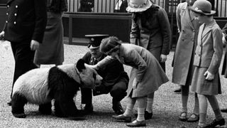 A young Princess Elizabeth and Princess Margaret meet a panda