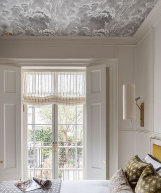 Bedroom ideas showing a room with wallpaper on the ceiling