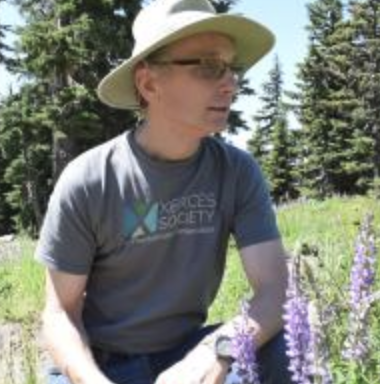 man in t-shirt wearing hat
