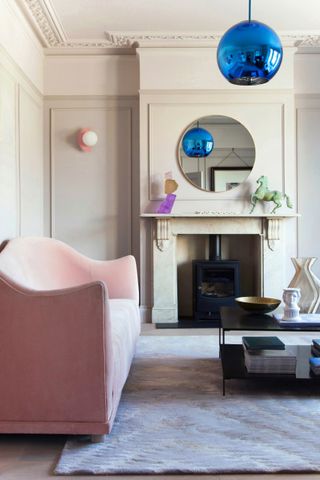 Pink and grey living room with metallic blue accents