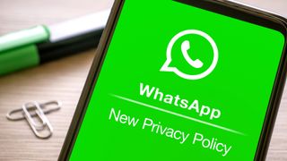 "Whatsapp new privacy policy" displayed on the green screen of a smartphone