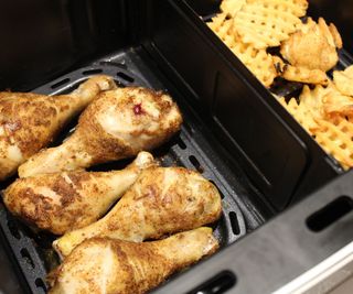 Cooking chicken and fries in the Beautiful 9-Quart TriZone Air Fryer