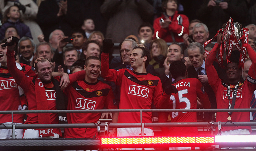 LONDON, ENGLAND - FEBRUARY 28: Patrice Evra of Manchester United lifts the Carling Cup trophy after the Carling Cup Final match between Aston Villa and Manchester United at Wembley Stadium on February 28 2010 in London, England. (Photo by John Peters/Manchester United via Getty Images)