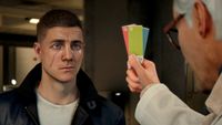 Q brandishes colour cards at a gormless Bond.