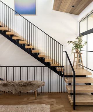 wooden stairway with simple iron balustrade