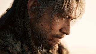 A man's grizzled face in side profile with a white background