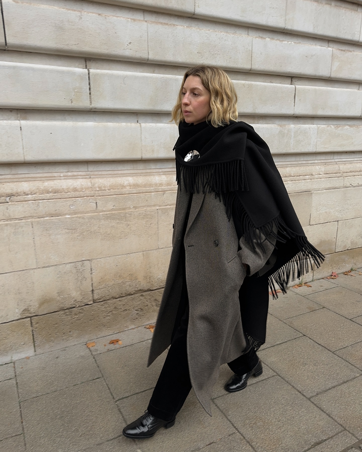 Brittany in a black scarf and greige coat