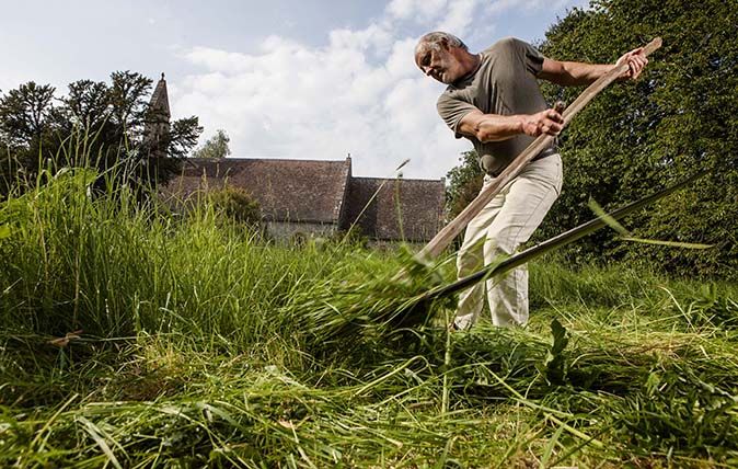 Scyther Nigel Adams in the churchyard at Pyrton Church, Oxfordshire. Pictures © Richard Cannon/Country Life Picture Library